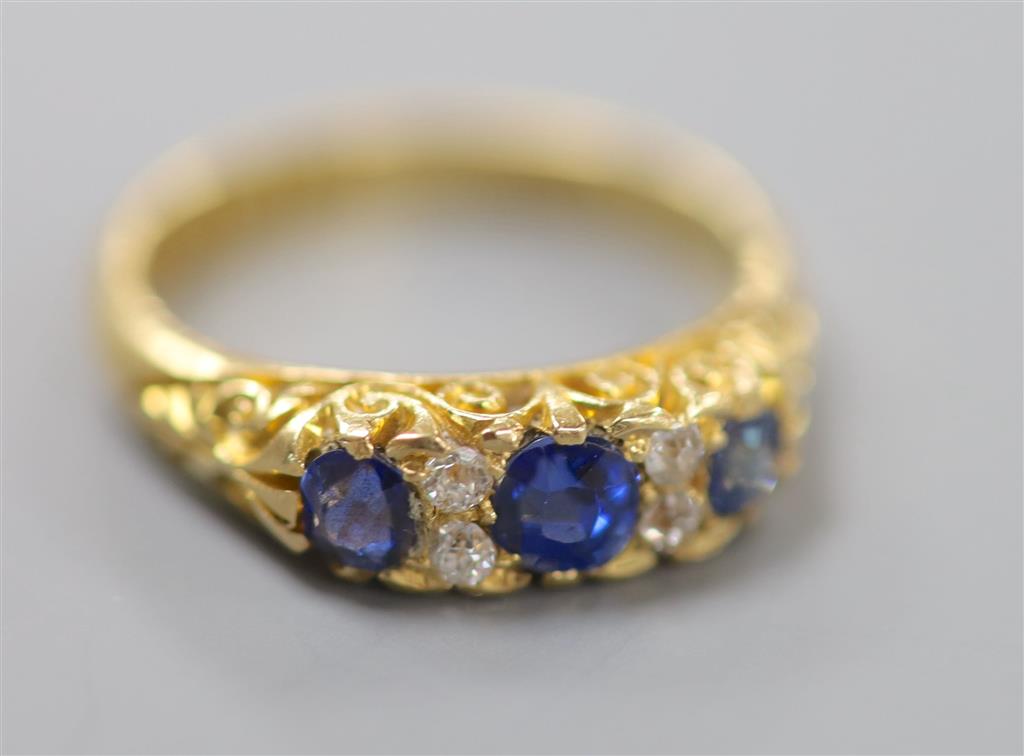 A late Victorian 18ct gold, three stone sapphire and four stone diamond chip set half hoop ring, size L, gross 4 grams.